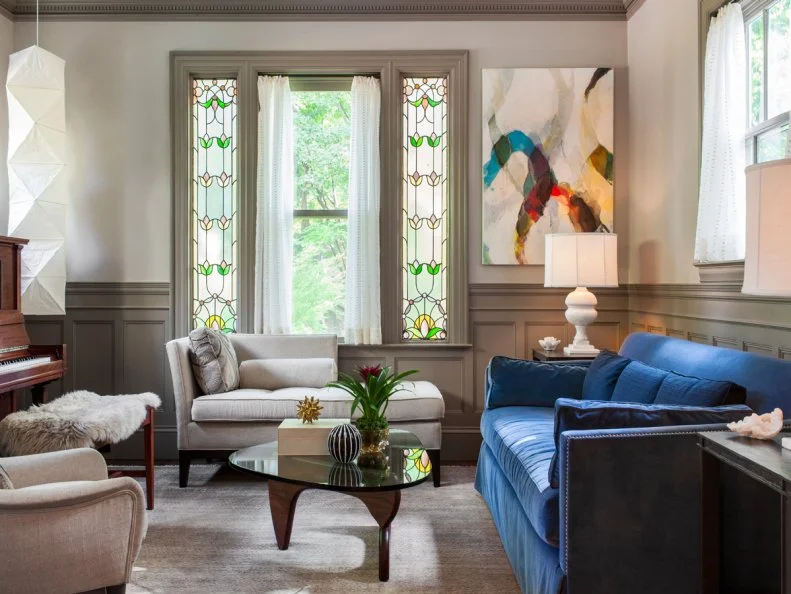 Transitional Neutral Family Room With Gray Wainscoting and Blue Sofa