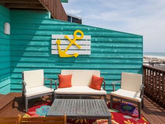 As seen on Beach Flip, Contestants Melissa and Madhi increased the appraised value of their beach deck by adding a new exterior table, a colorful rug and a comfortable seating area at the renovated Coastal Calm condo. (after)