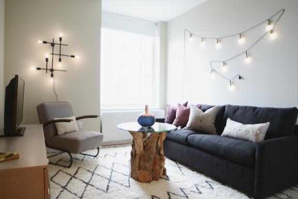 Contemporary Neutral Living Area With Black Sofa and White Rug