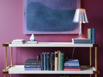 Contemporary White Bookshelf With Gold Accents in Purple Room
