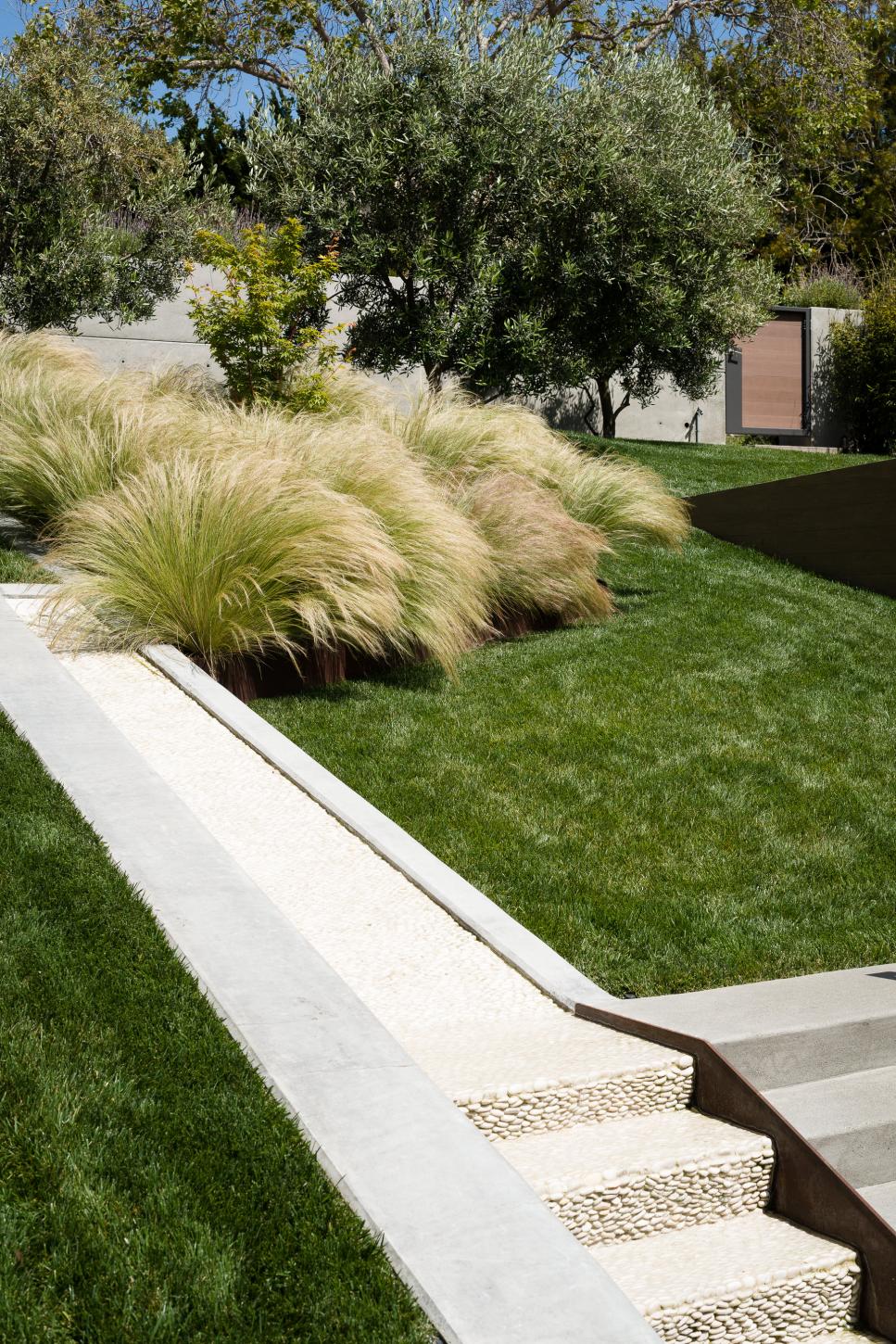 Modern Outdoor Space with Pebbled Stairs Pebbled Neutral Stairs in Green Foliage Rich Outdoor Space