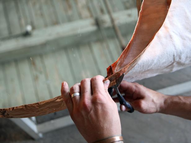 Cut away the excess copper flashing with scissors, allowing the two ends to overlap about 1/2-inch.