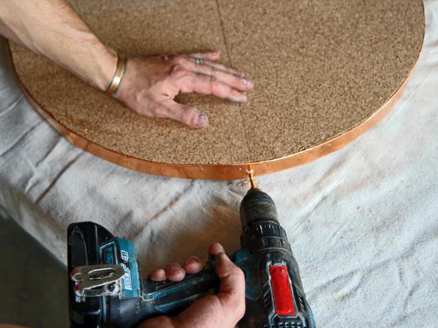 Drill a hole on each side with a 1/8" drill bit through the copper flashing and into the plywood.