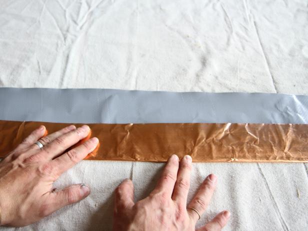 Fold the copper flashing over on one edge about a third of the width.