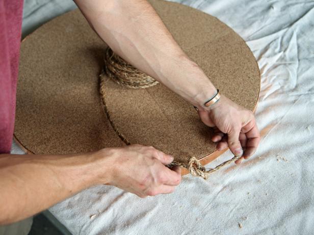 Loop 1/4" sisal rope through one of the screw eyes, and tie a knot.