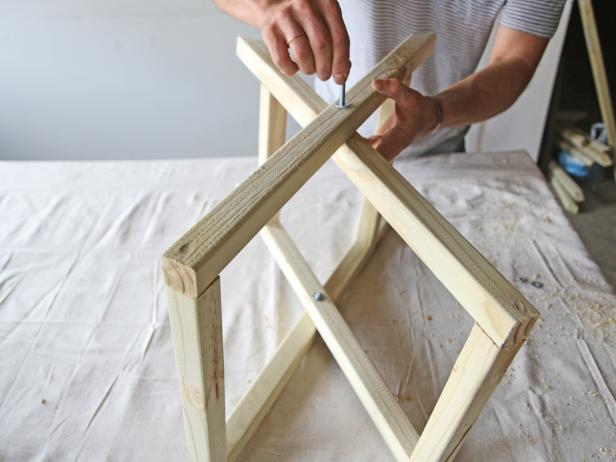 Attach the legs together in an X pattern using a 3” x ¼” bolt with a 1/4” washer.