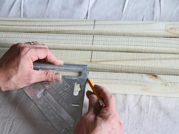 Using a speed square and pencil, draw a straight line on the 25" marks on the four balusters.