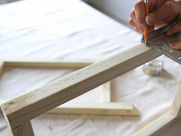 Use a speed square to mark the center of the leg at each 12” mark.