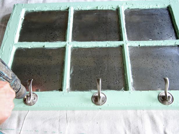 Place decorative coat and hat hooks over the center mark, and secure with hardware screws.