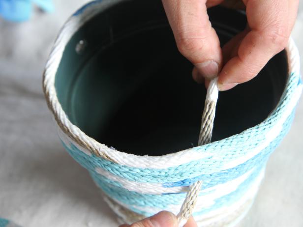 Insert rope through pre-drilled holes in pot.
