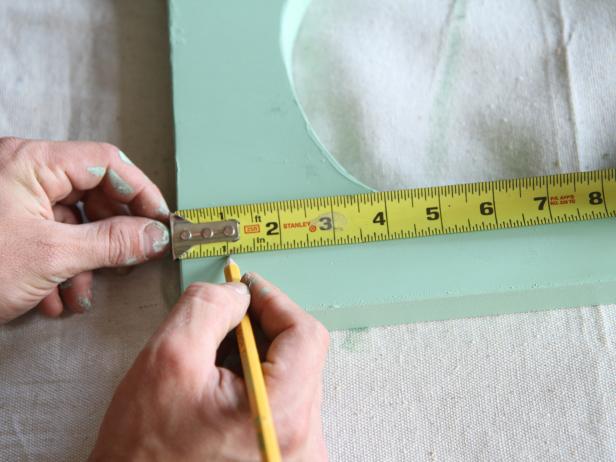 On the underside of the stair tread, measure and mark 1” from each corner with a pencil.