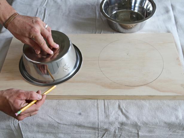 Trace each bowl onto the wood using a pencil
