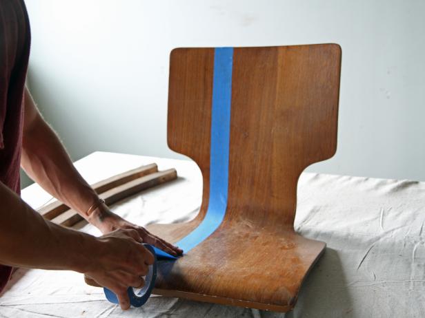 Tape a stripe on one side of the wooden seat with painter’s tape.