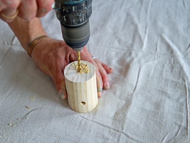 Drill a hole in the center on the face of the dowel with a 3/16” drill bit.