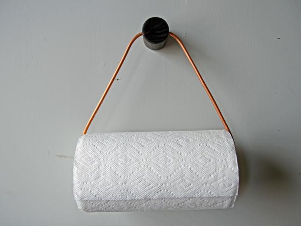 Add a stylish touch to your kitchen by displaying a DIY copper paper towel holder.