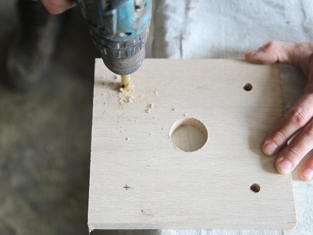 Drill a hole on each plus mark using a 1/2” drill bit.