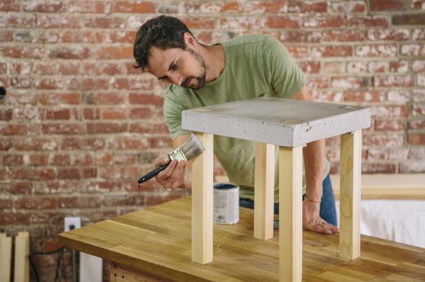 Apply polyurethane to legs with a paintbrush to protect the wood.