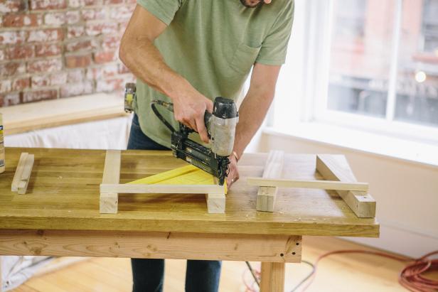 Attach brace to table legs using a speed square and nail gun.
