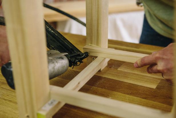Attach braces to table legs with a nail gun.