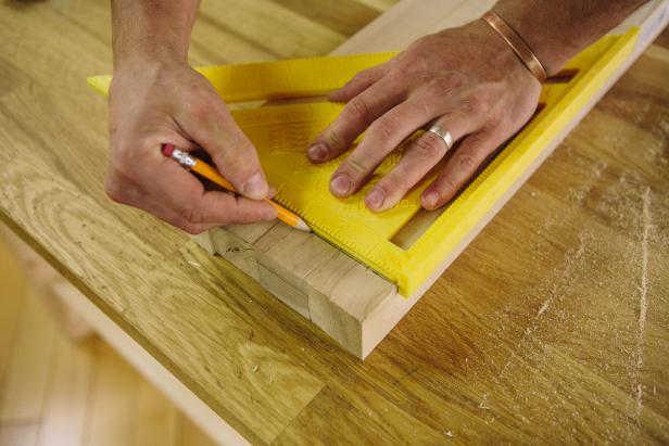 Mark a line across four balusters using a speed square.