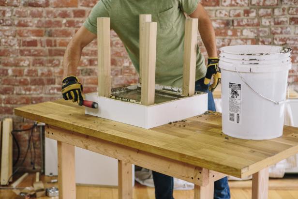Tap the outside of the melamine form to release air bubbles in the concrete.