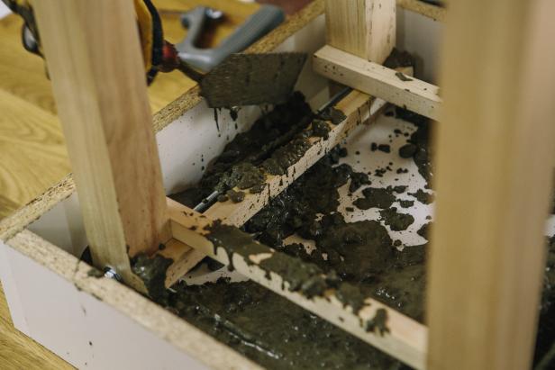 Trowel concrete into melamine table form and let dry overnight.