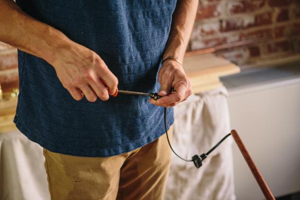 Assemble plug to copper piping to make an industrial-style sconce.