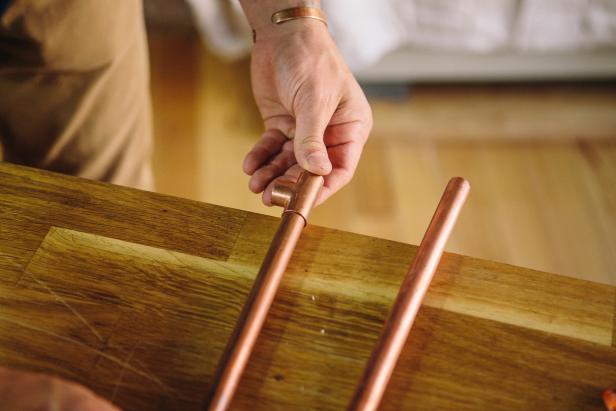 Attach tees to ends of copper piping to make an industrial-style sconce.