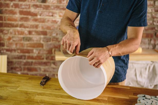Apply tape to the plastic bucket before you attach the tile sheets.