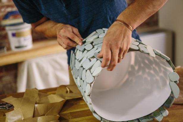 Attach the stone tile sheets to the plastic bucket.