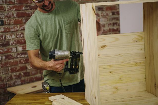 Attach cabinet backing using a nail gun.