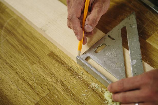 Mark a line across the wood piece before cutting.