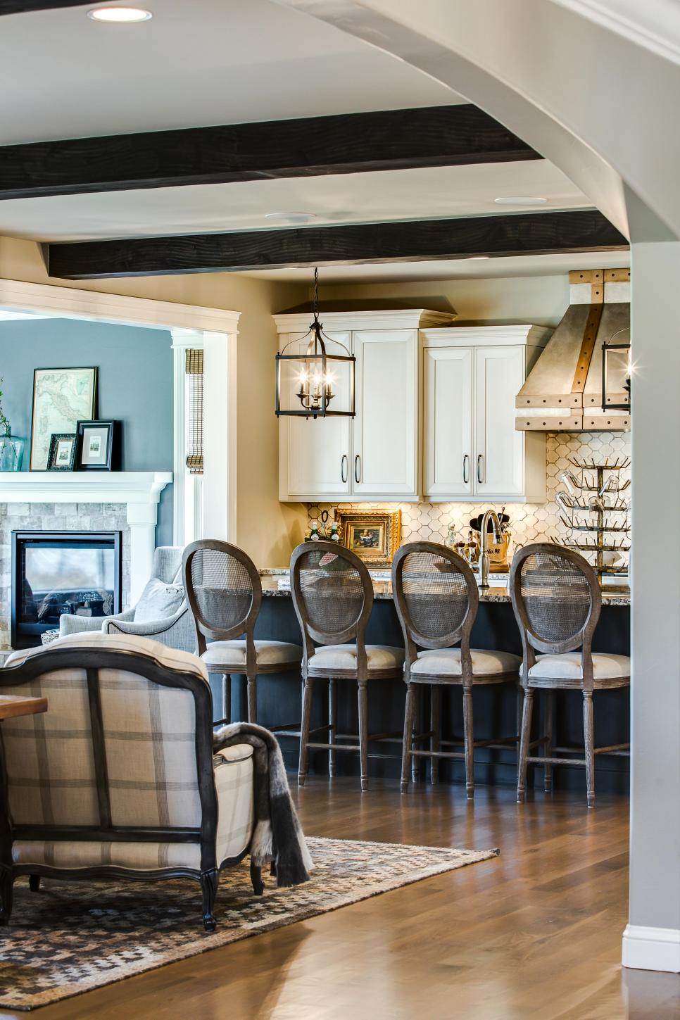 Traditional Open Plan Kitchen Boasts Country Flair Wood Barstools Lining Island in Traditional Neutral Kitchen