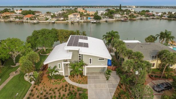 Green Exterior With White Roof and Solar Panels Green Exterior With White Roof and Solar Panels