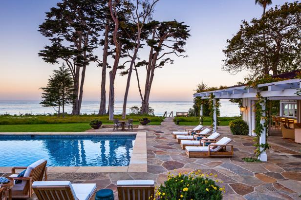 Contemporary Stone Patio With White Cushioned Lounge Chairs and Beach Access Contemporary Stone Patio With White Cushioned Lounge Chairs and Beach Access