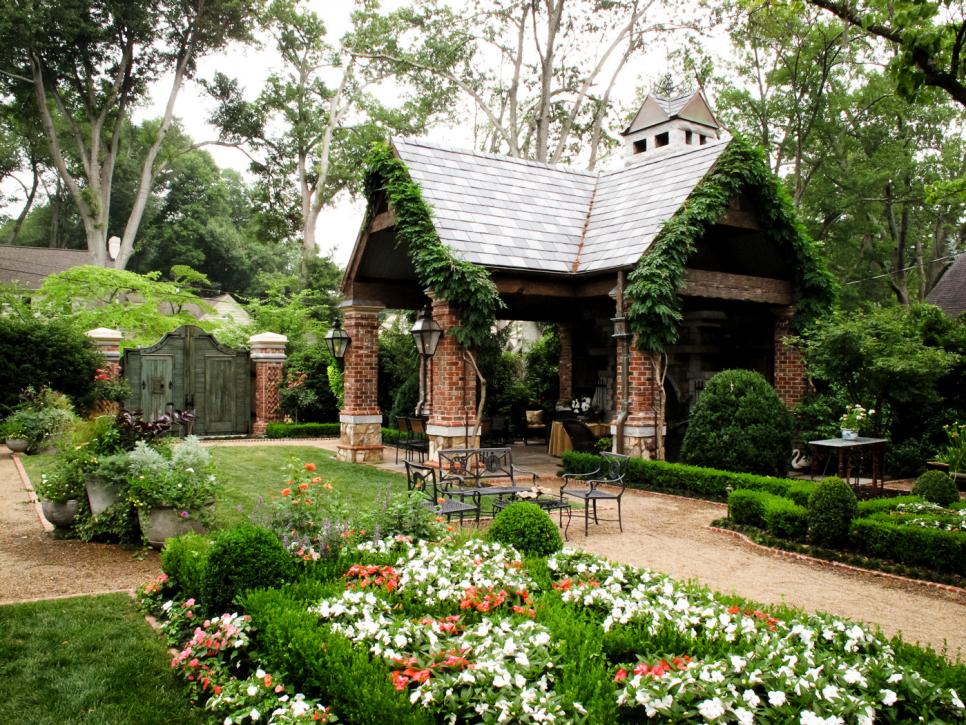 Brick Pavilion With Weathered Gate and Ivy on Roof Peaks HGTV