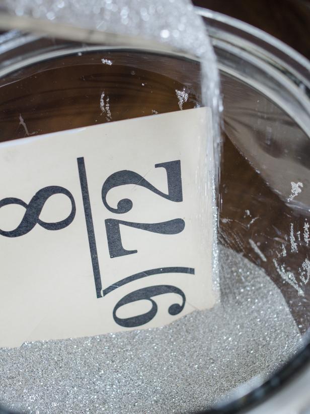 Sprinkle glitter over wet glue until coated. Shake excess glitter off into a container to reuse.