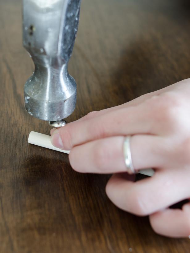 Tap tack gently in with hammer, so it goes mostly through the dowel without coming out the other side. Tap tack in slowly, being careful to not split the dowel rod.
