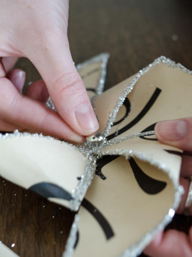 Remove tack from the dowel and push it through center of pinwheel, then press into “pilot hole” made in the dowel. Tip: Don’t push it in too far, so the pinwheels have room to spin.