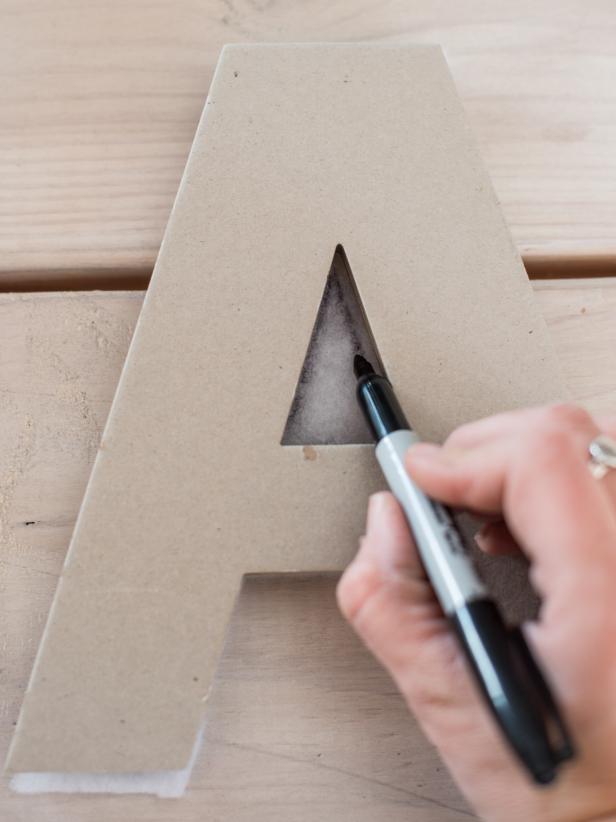 Place each letter on one layer of lightweight quilt batting and trace the letter onto the batting with permanent marker. Use scissors to cut out each letter along drawn lines.