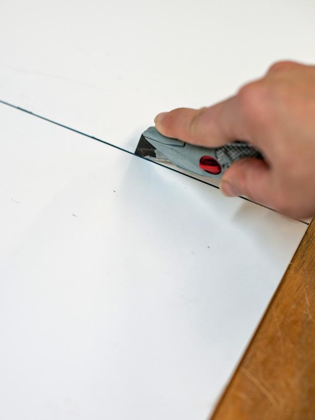 Use a carpenter’s square to measure out a template on white foam core board that is 12” square. Mark out square with permanent marker and cut on both lines with a utility knife. Tip: A larger square may be required if curtain rod hardware will be positioned wider and/or higher than the 12” square will allow. The 12” square should work in most cases, though.