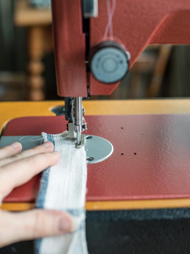 . Fold one fabric strip in half with right sides together and sew one short side and long side where edges meet.