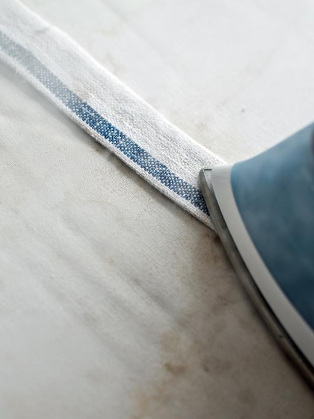 Iron tie, so it lays flat. Repeat with three other ties. Tip: Ribbons may also be used to skip this step.
