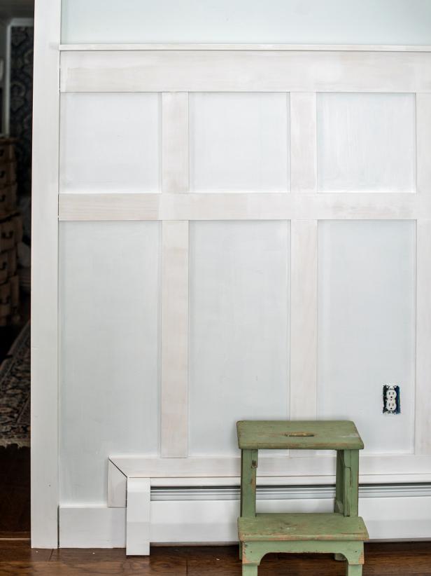 Use paintable trim caulk and a caulk gun to fill cracks and lines where wood pieces meet each other, baseboards, moldings, and the wall. Allow caulk to completely dry prior to priming. Fill nail holes with wood filler, working it into each nail hole with a fingertip. Lightly sand filler smooth with 180-grit paper once it is dry. Apply primer to walls and wood using a foam trim roller and 2” angled sash paintbrush. Allow primer to completely dry. In the same manner, paint on trim paint in desired color and finish. Allow paint to dry.