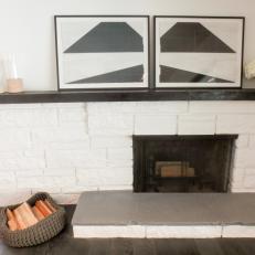 White Painted Brick Fireplace Surround With Small Gray Hearth and Thin Mantel Displaying Modern Art 