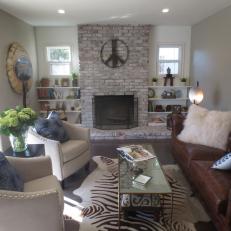Contemporary Living Room With Brick Fireplace Surround, Brown Leather Tufted Couch and Nailhead Trim Neutral Chairs