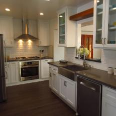 Cozy Transitional Kitchen With Textured White Tile Backsplash, Farmhouse Sink and Dark Neutral Countertop 