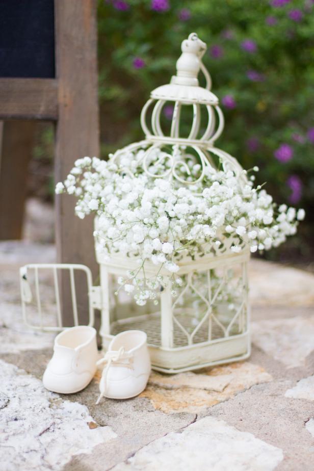 Add a “found at a French marketplace” vibe with a vintage birdcage filled with baby’s breath and a pair of antique babydoll shoes.