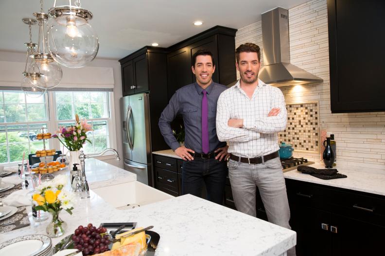 Hosts Drew (L) and Jonathan Scott (R) pose for a portrait in the newly-remodeled master kitchen of Tom and Brdiget Suvansri's home in Stamford, Connecticut, as seen on Property Brothers. (portrait)