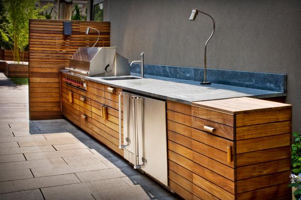 Modern Outdoor Kitchen With Wooden Panels and Brushed Steel 